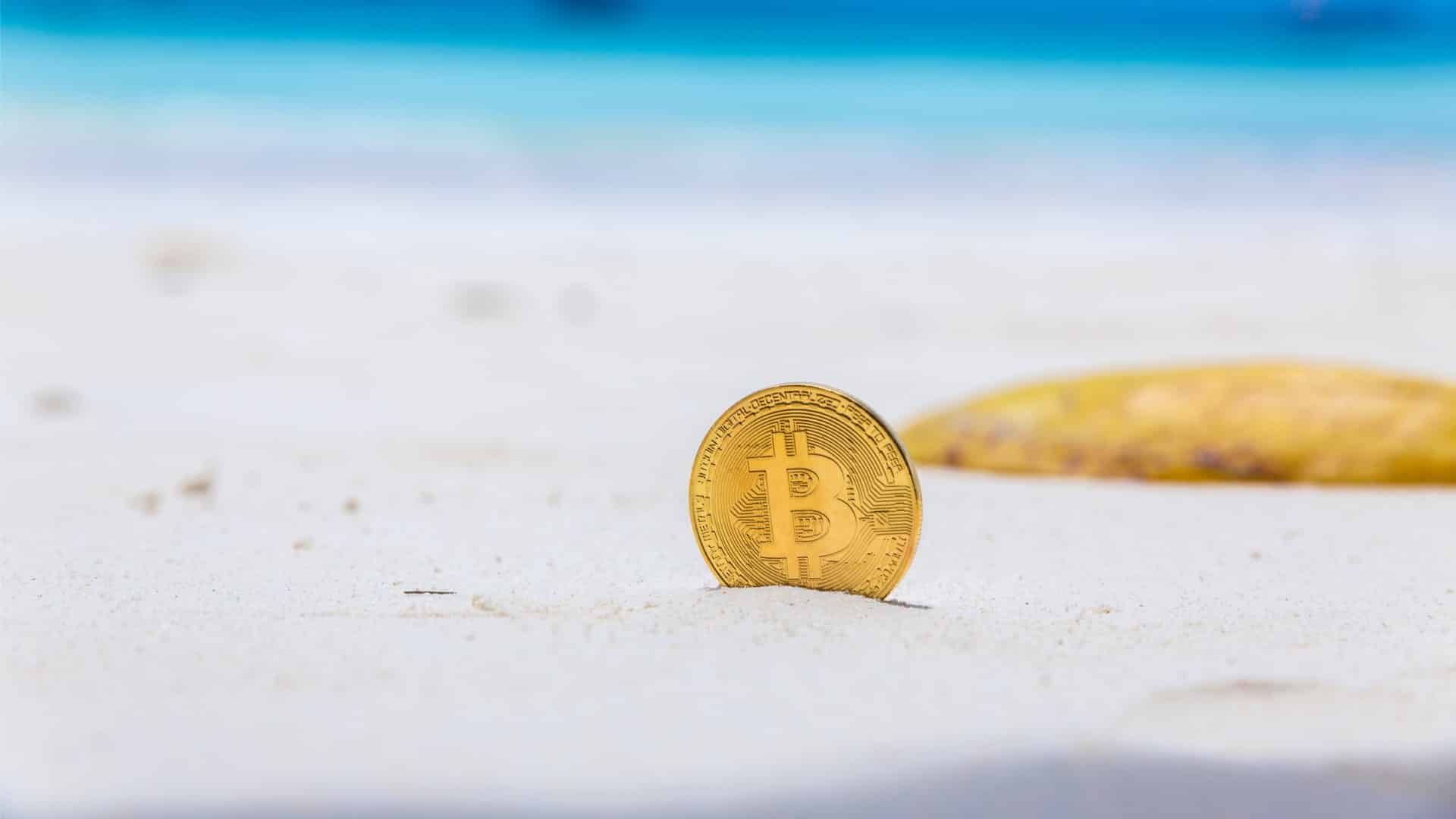 Bitcoin enterrado na areia da praia