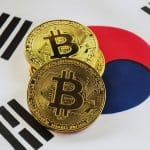 Moedas de Bitcoin sobre bandeira da Coréia do Sul.