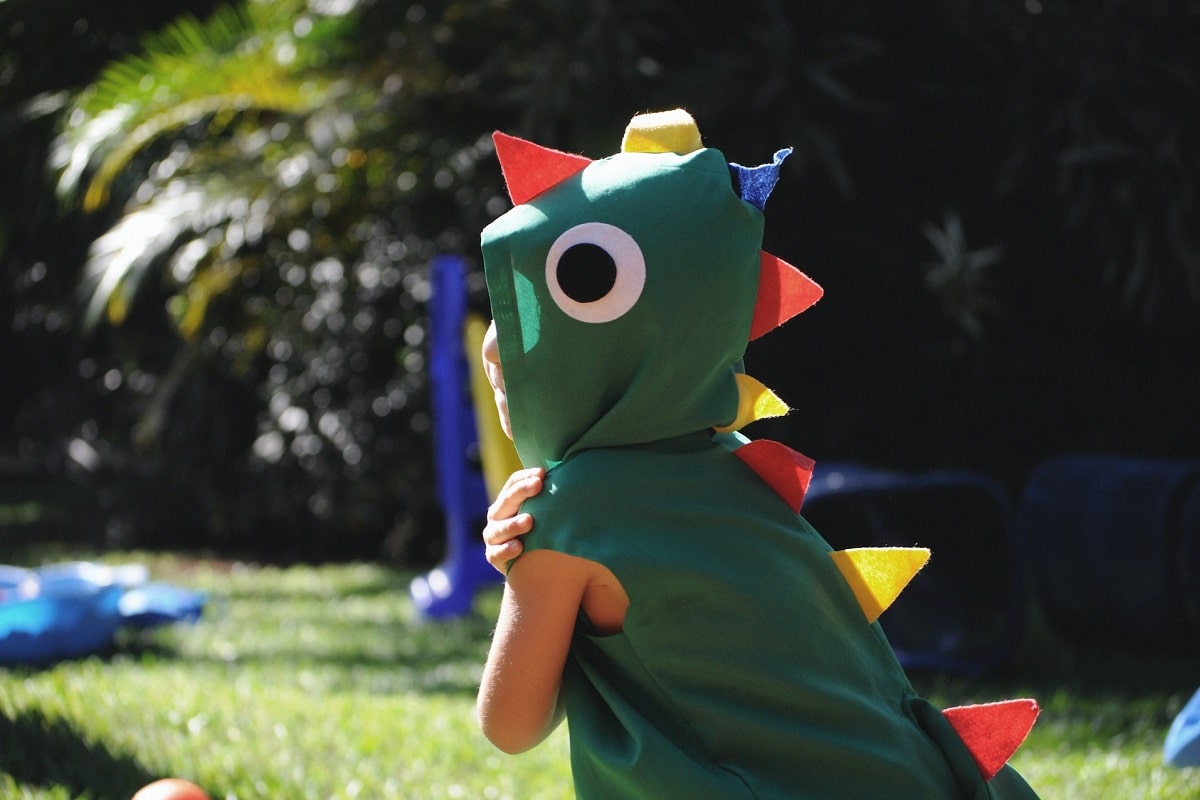 Criança com fantasia de dinossauro